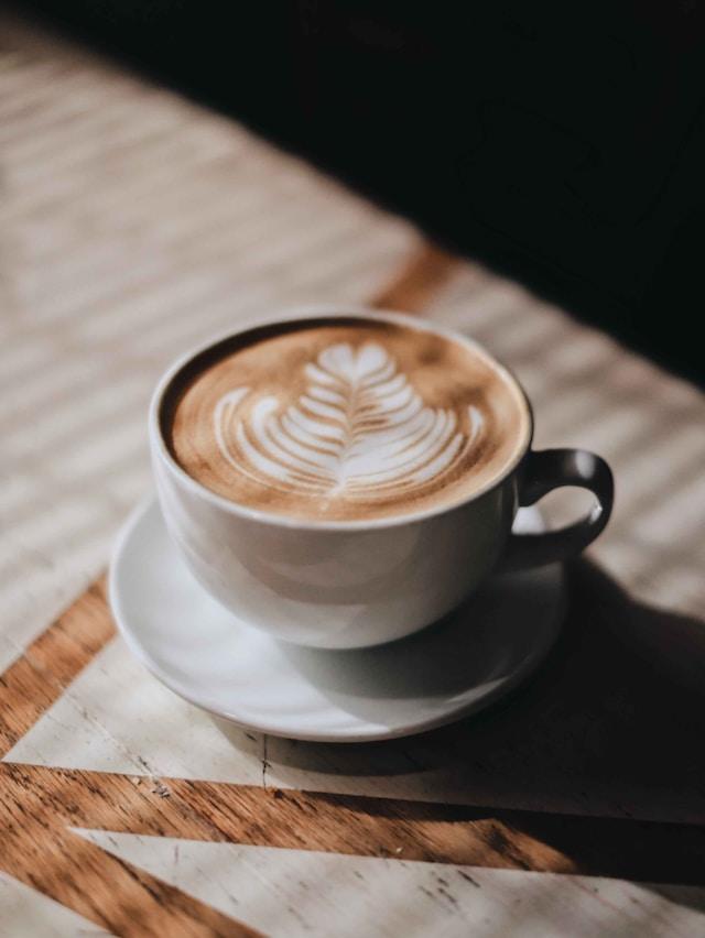 latte with flower art in mug